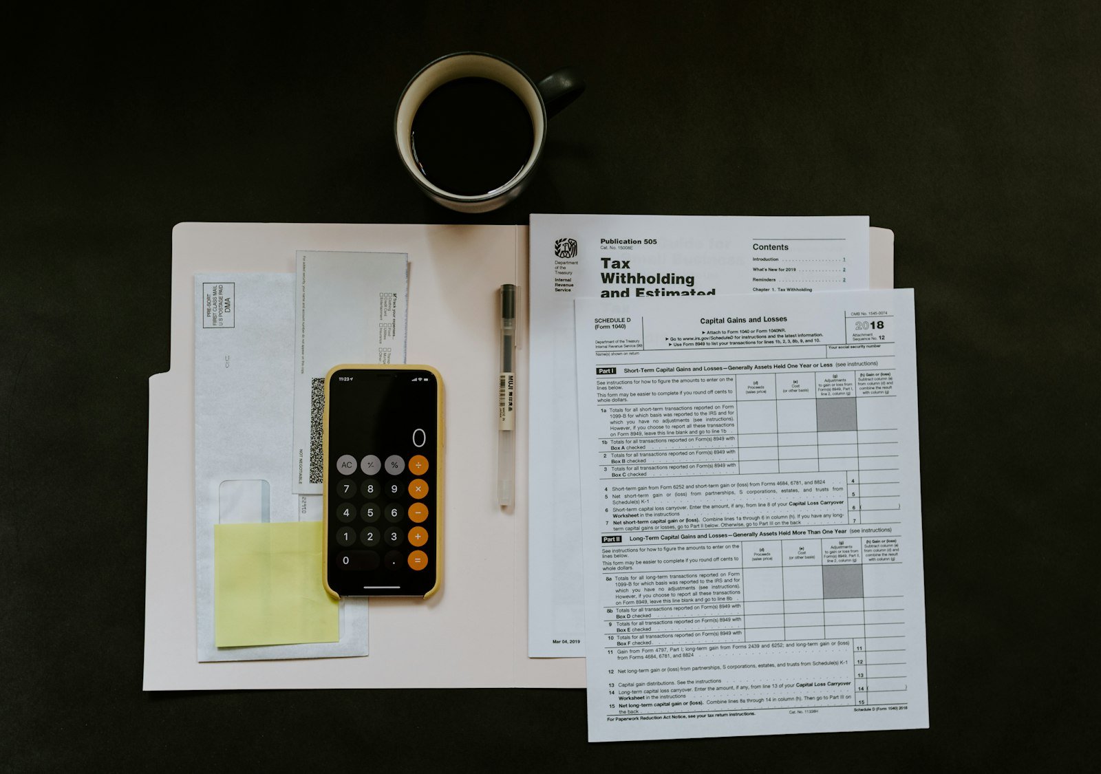 Official forms, a calculator and a coffee cup on a desk, standing in for records that have to exist before a report is due