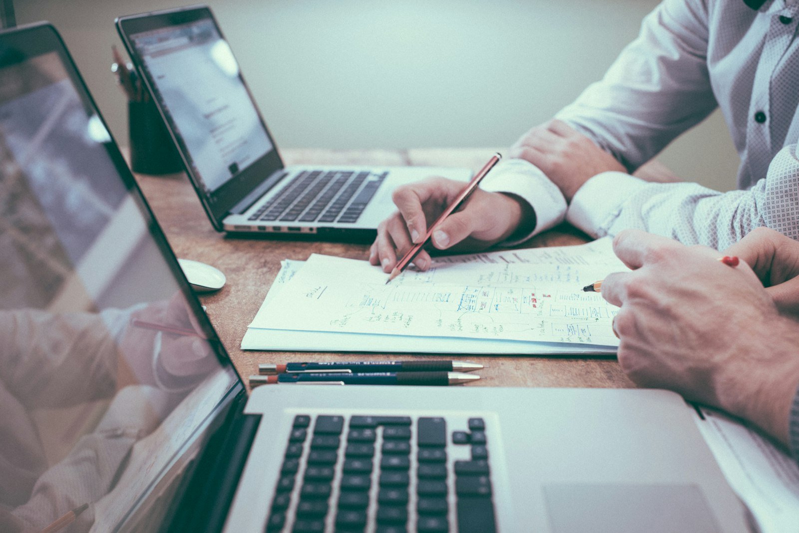Document stacks on a conference table for legal, finance and IT work