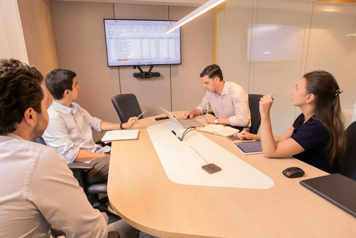 Leadership team discussing strategy around a conference table