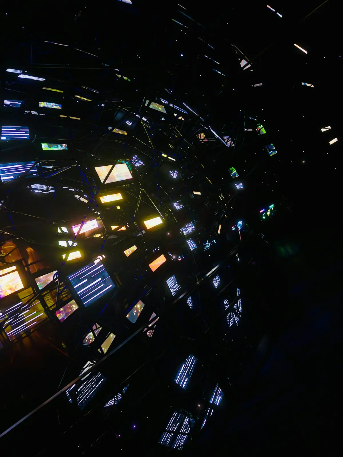 Abstract network of illuminated screens in darkness