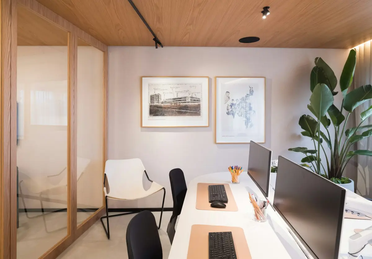 Modern workspace with computers and organised knowledge tools